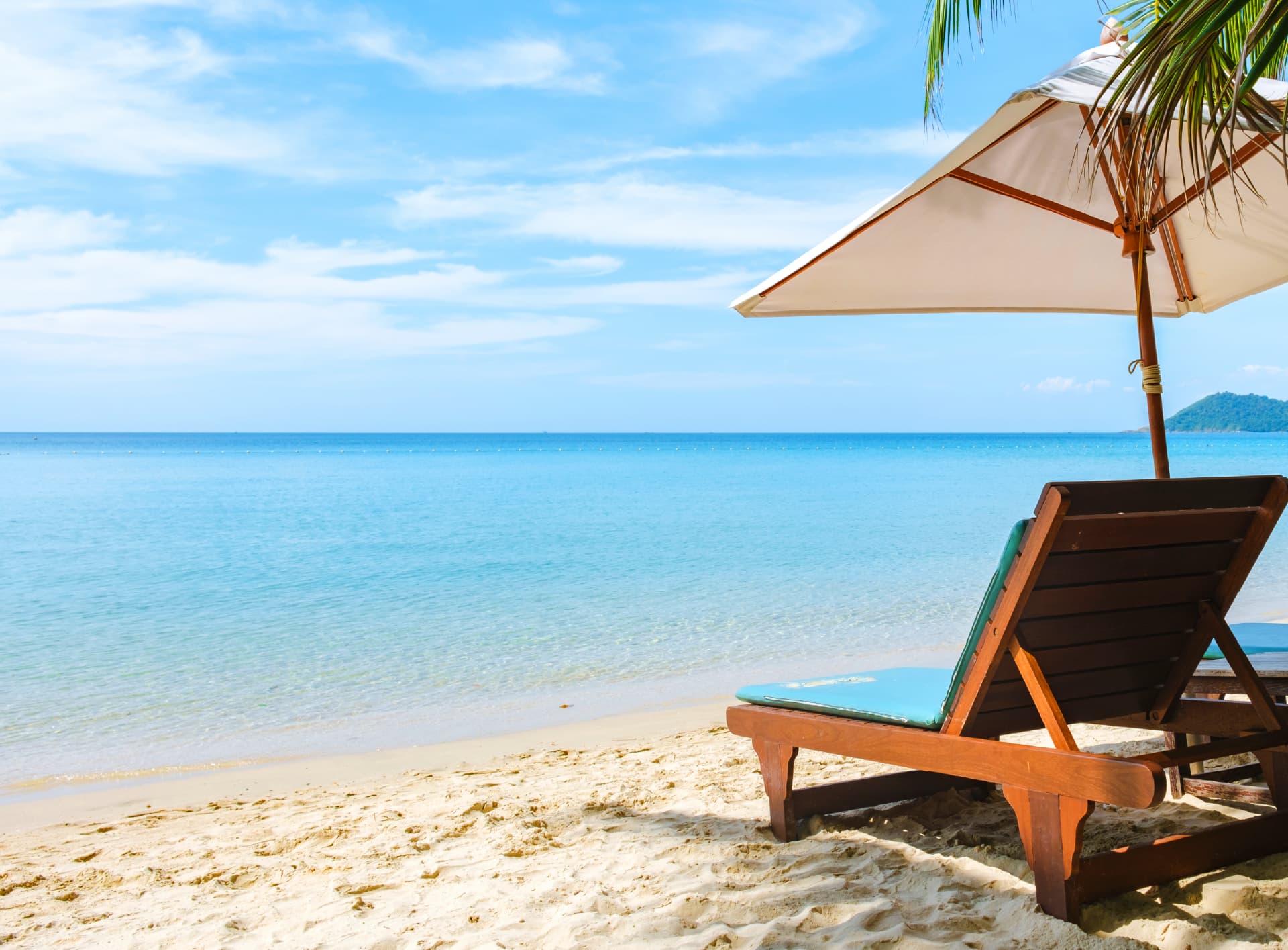 A shaded lounger facing the sea at a Seven Cities holiday home
